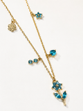 Collana dorata con fiore e cristalli azzurri