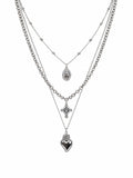 Collana multistrato argentata con cuore sacro e croce