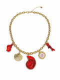 Collana dorata con charms marini rossi e conchiglie