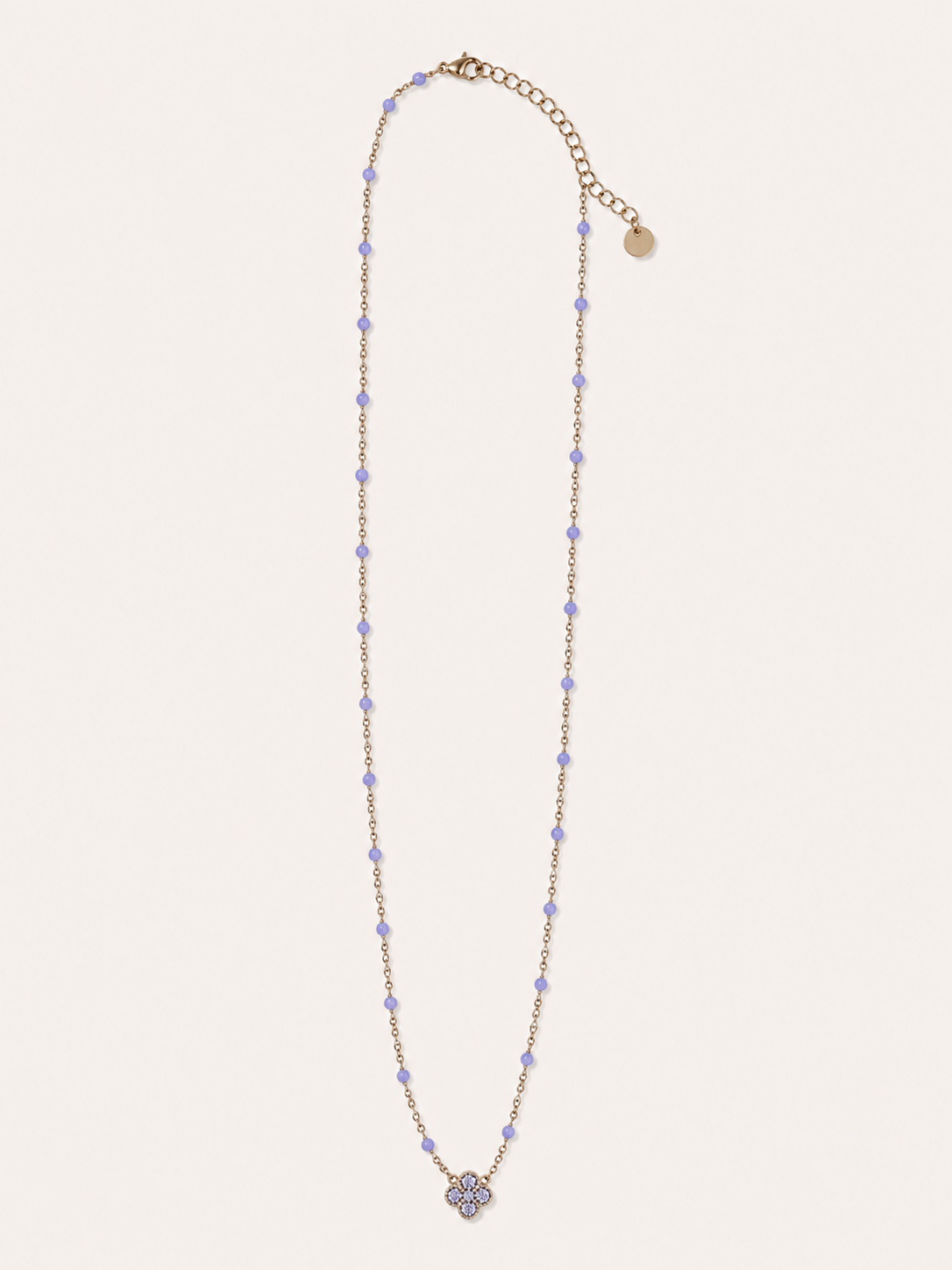 Collana dorata con fiore e dettagli lilla